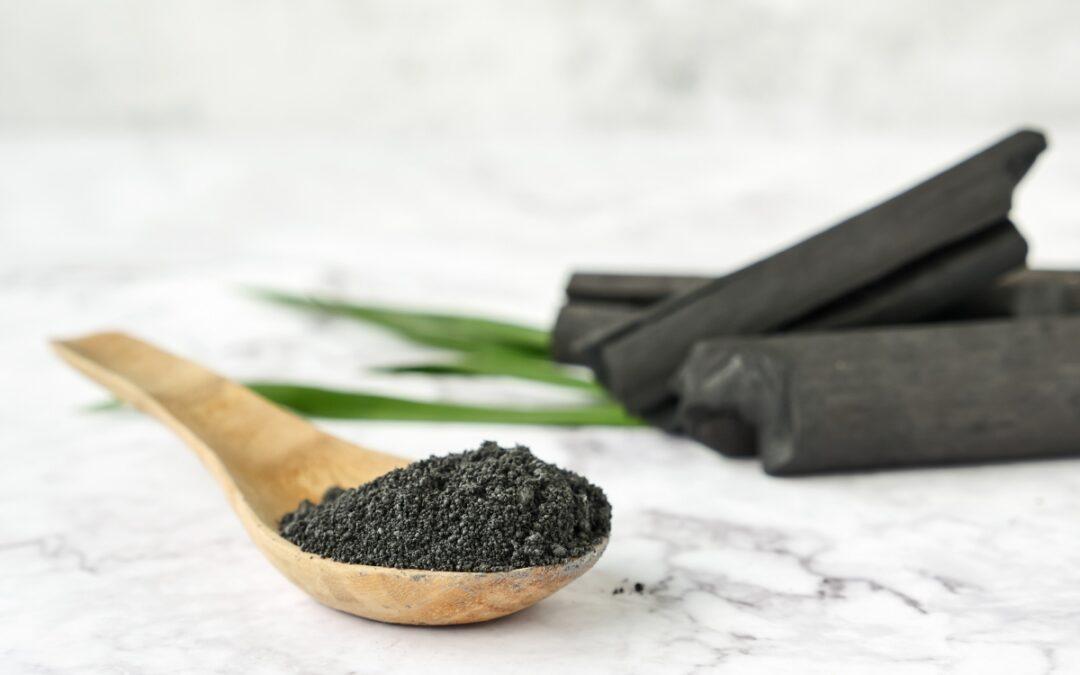 Charcoal on a spoon one of the main ingredients in sacred ash detox superfood powder